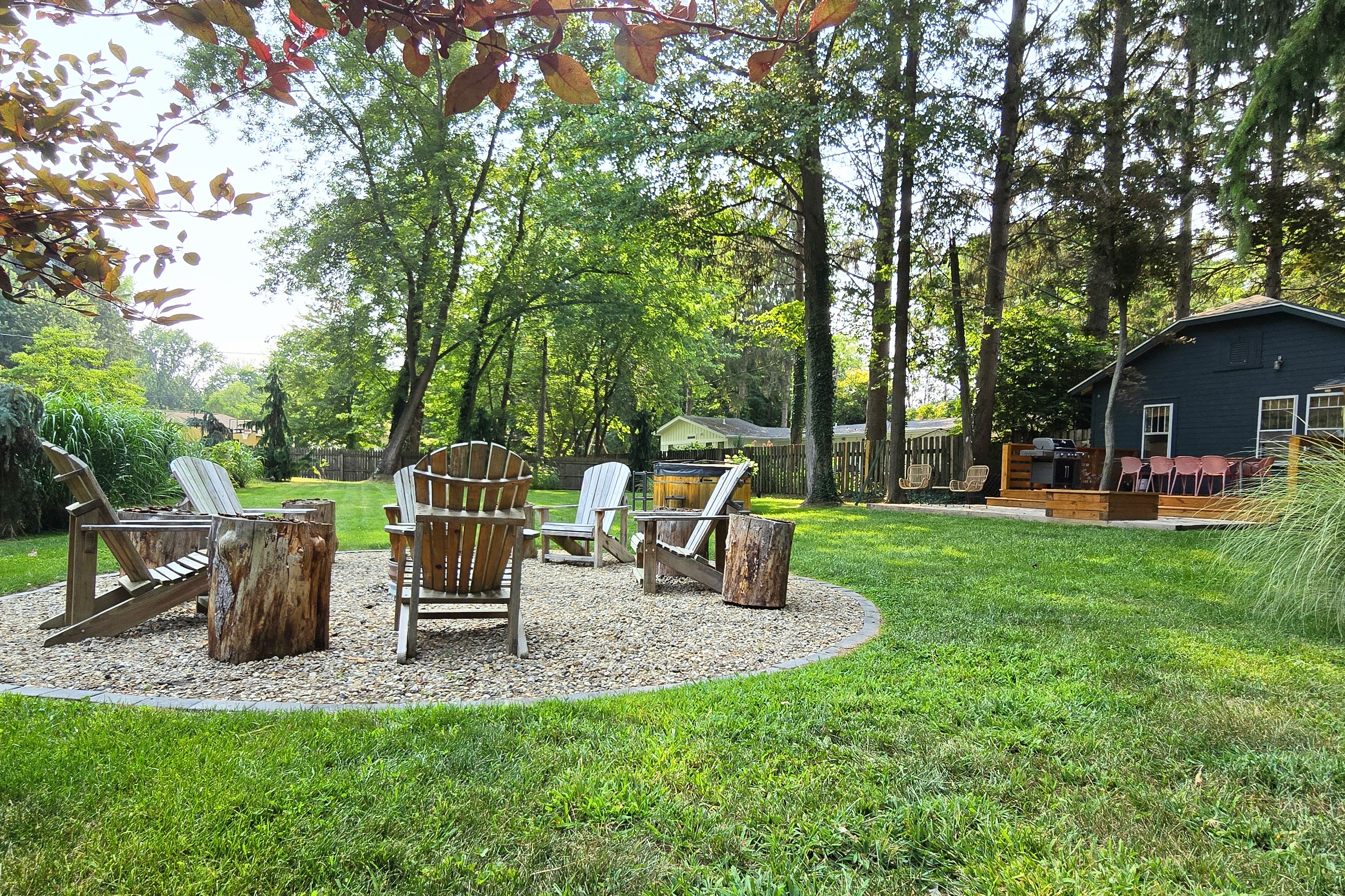 Fire pit and Adirondack chairs in the backyard