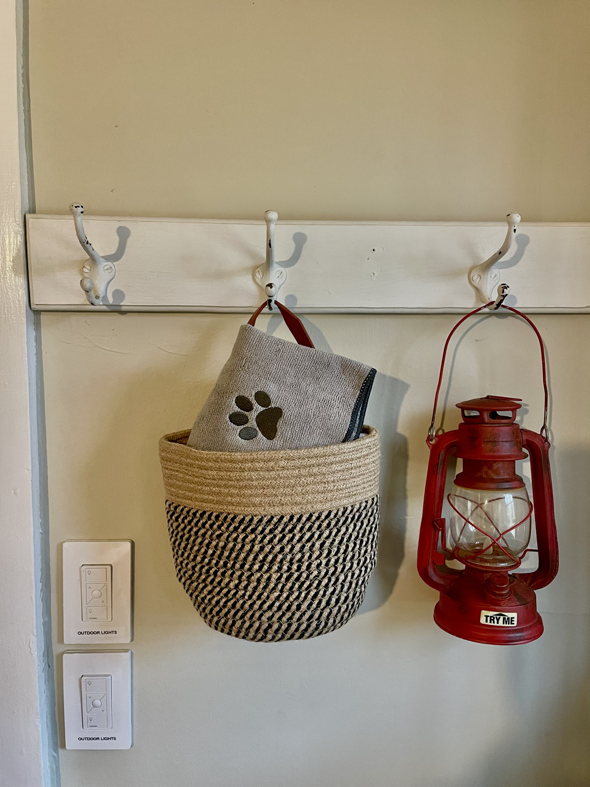 Mudroom coat hooks with pet towel basket and red lantern