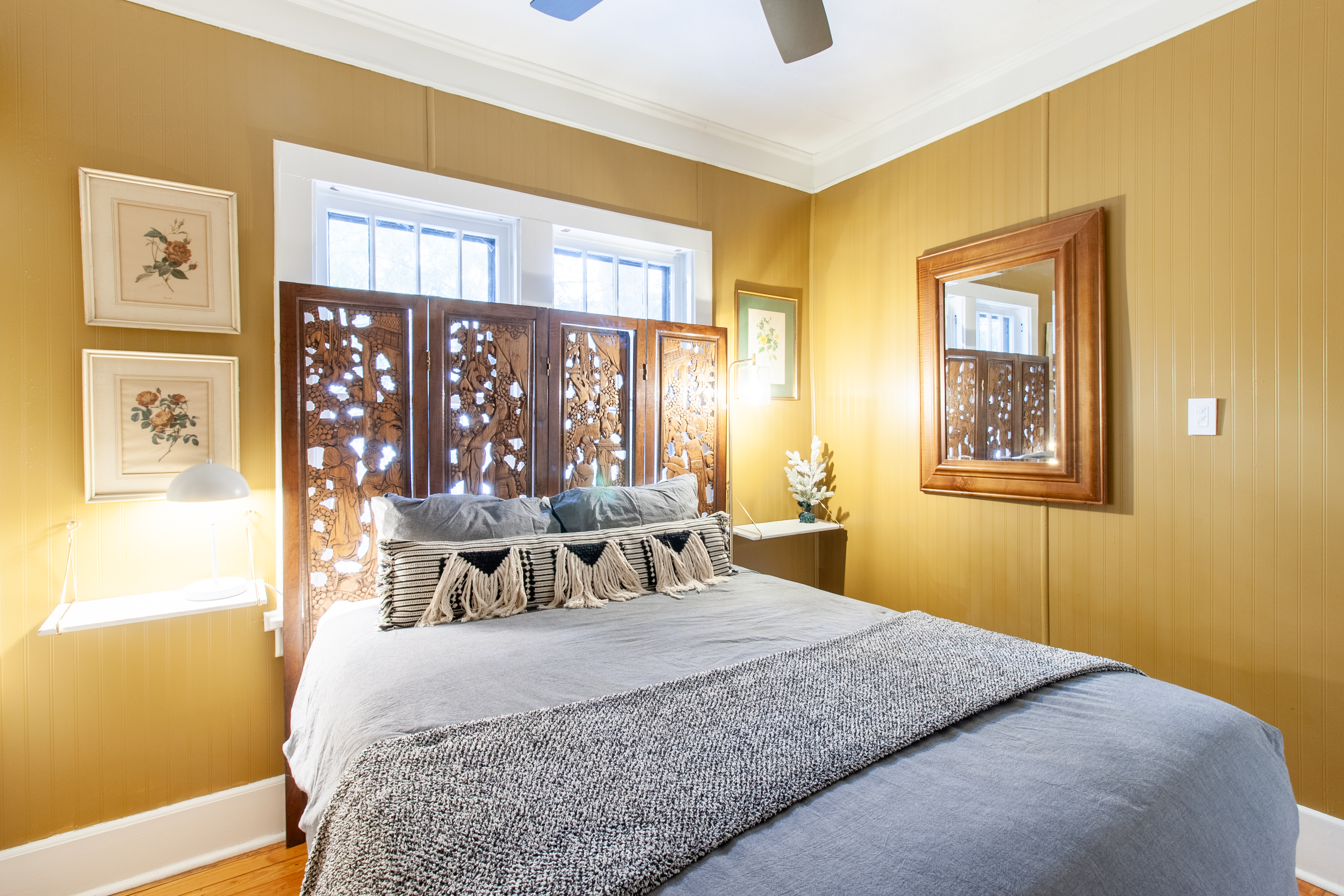 Bedroom with gold walls and queen bed